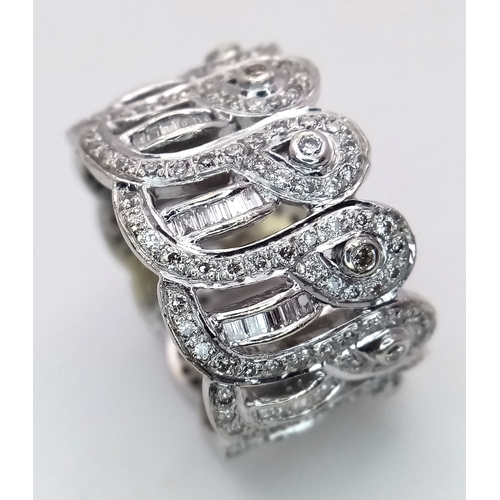 47 - An 18K White Gold and Diamond Regal-Esque Ring. Crown form, with baguette and round cut diamonds thr... 