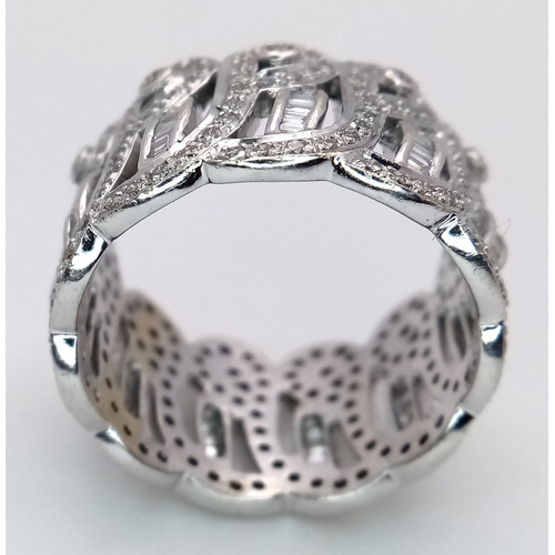 47 - An 18K White Gold and Diamond Regal-Esque Ring. Crown form, with baguette and round cut diamonds thr... 