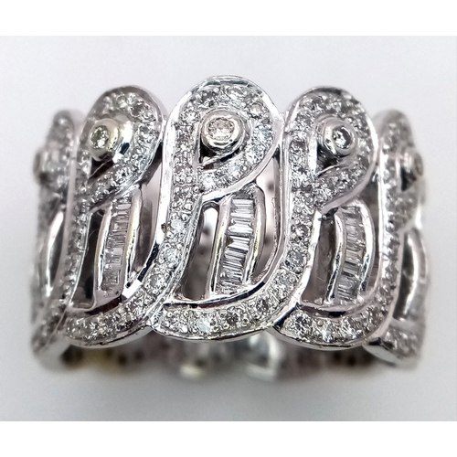 47 - An 18K White Gold and Diamond Regal-Esque Ring. Crown form, with baguette and round cut diamonds thr... 
