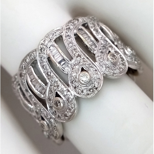 47 - An 18K White Gold and Diamond Regal-Esque Ring. Crown form, with baguette and round cut diamonds thr... 
