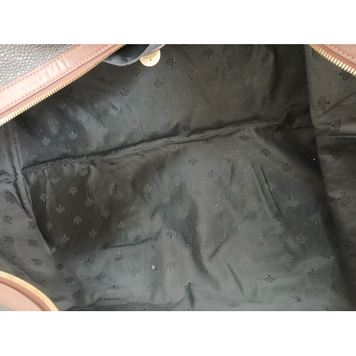 153 - A Mulberry Black Weekend Bag. Pebbled leather exterior with gold-toned hardware, two textile handles... 