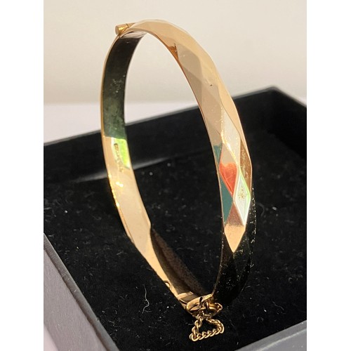 28 - Vintage Hinged ROLLED GOLD BANGLE. Beautifully faceted. Complete with safety chain. 18.7 grams.