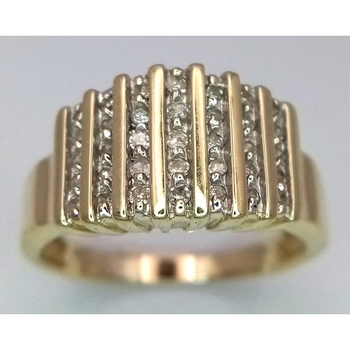 165 - A 10K Yellow Gold Graduating Channel Set Diamond Ring. Size R. 4.52g total weight.