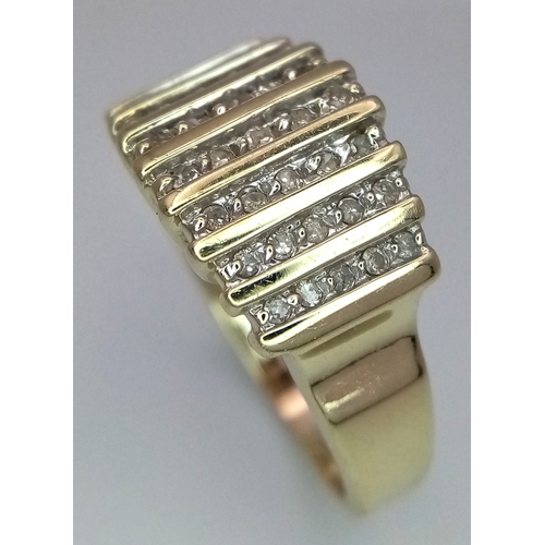165 - A 10K Yellow Gold Graduating Channel Set Diamond Ring. Size R. 4.52g total weight.