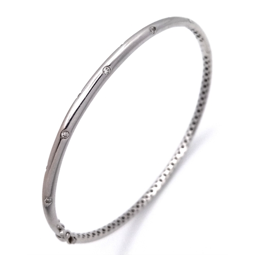 19 - AN 18K WHITE GOLD DIAMOND SET BANGLE. 9.1G. SC-1070