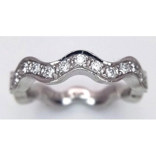 40 - AN 18K WHITE GOLD WAVY DIAMOND BAND RING - 0.20CTW. 5.5G. SIZE L. SC - 1096.