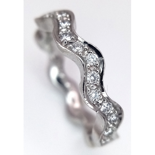 40 - AN 18K WHITE GOLD WAVY DIAMOND BAND RING - 0.20CTW. 5.5G. SIZE L. SC - 1096.