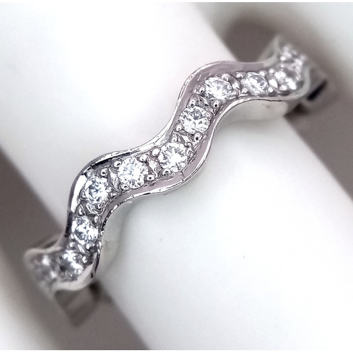 40 - AN 18K WHITE GOLD WAVY DIAMOND BAND RING - 0.20CTW. 5.5G. SIZE L. SC - 1096.