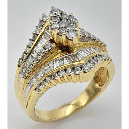 13 - An 18K Yellow Gold and Diamond Ring. Shield form diamond mirrored setting with tapered baguette and ... 