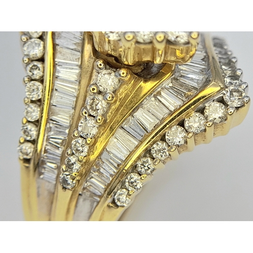 13 - An 18K Yellow Gold and Diamond Ring. Shield form diamond mirrored setting with tapered baguette and ... 