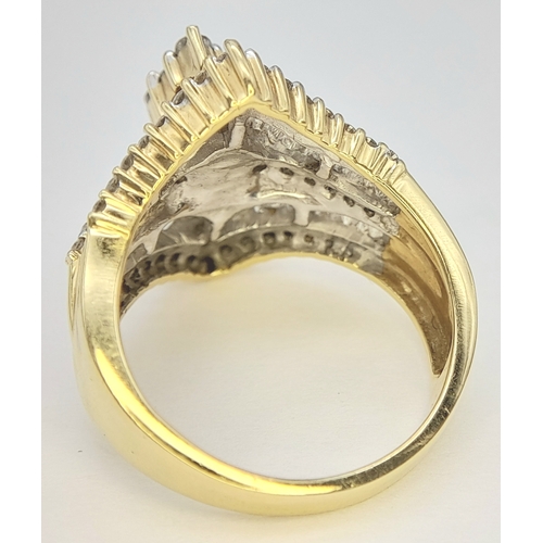 13 - An 18K Yellow Gold and Diamond Ring. Shield form diamond mirrored setting with tapered baguette and ... 