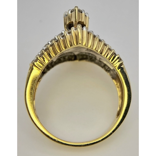 13 - An 18K Yellow Gold and Diamond Ring. Shield form diamond mirrored setting with tapered baguette and ... 