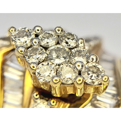 13 - An 18K Yellow Gold and Diamond Ring. Shield form diamond mirrored setting with tapered baguette and ... 