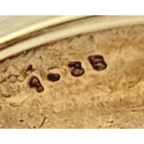 13 - An 18K Yellow Gold and Diamond Ring. Shield form diamond mirrored setting with tapered baguette and ... 