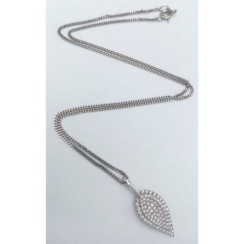 29 - An 18K White Gold Diamond Leaf Form Pendant on an 18K Gold Disappearing White Necklace. c.0.90ctw. 2... 