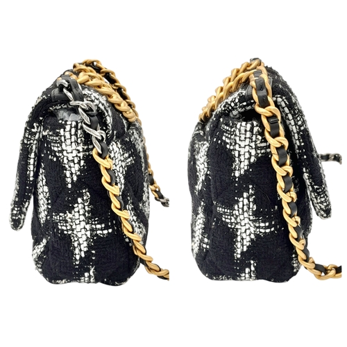 34 - A Chanel Black and White Tweed Flap Bag. Quilted tweed exterior with gold toned hardware, leather-in... 
