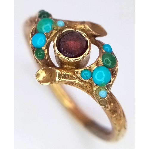 25 - An Antique 18K Gold (tested) Turquoise and Garnet Ring. Central garnet with graduating turquoise cab... 