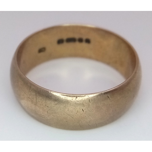 9 - A 9K Yellow Gold Band Ring. Full UK hallmarks. 8mm width. Size U. 6.9g.