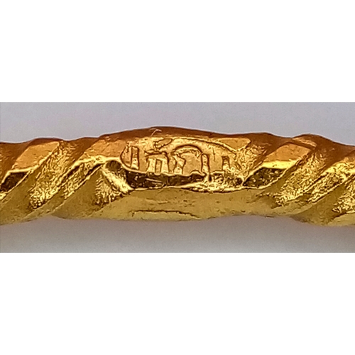 52 - An 18K Yellow Gold (test as) Bangle with Geometric Pattern. 3mm width. 65mm inner diameter. 10.1g.