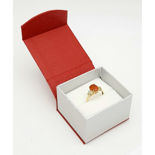 43 - A 14K Yellow Gold, Fire Opal and Diamond Ring. Oval cut 1.5ct fire opal with tapered baguette diamon... 