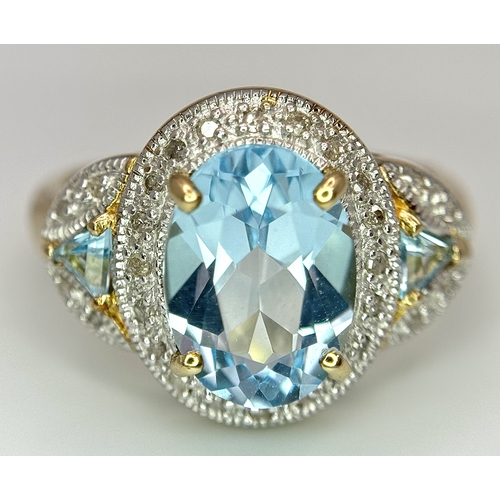 19 - A 14K Yellow Gold, Blue Topaz and Diamond Ring. 3ct oval cut, ice blue central topaz with 0.14ctw of... 