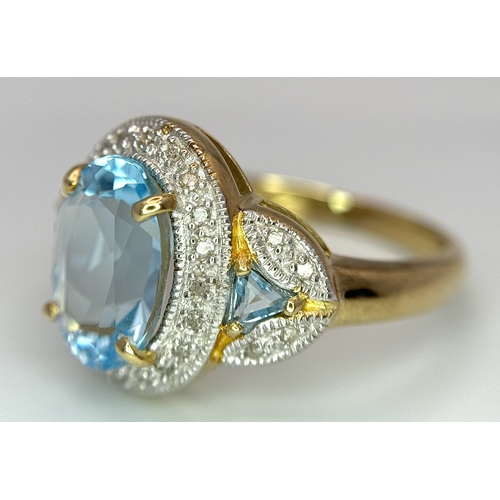 19 - A 14K Yellow Gold, Blue Topaz and Diamond Ring. 3ct oval cut, ice blue central topaz with 0.14ctw of... 