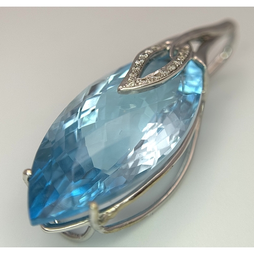 41 - A 20ct Marquise Cut Ice Blue Topaz in an 18K White Gold and Diamond Cage - Pendant. 7g total weight.... 