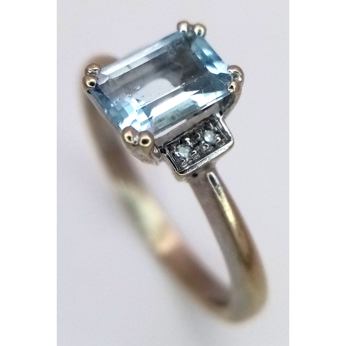 344 - A 9K Yellow Gold Emerald Cut Blue Topaz and Diamond Ring. 1ct centre stone with diamond accents. Siz... 