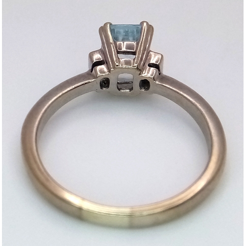 344 - A 9K Yellow Gold Emerald Cut Blue Topaz and Diamond Ring. 1ct centre stone with diamond accents. Siz... 