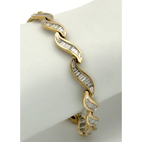 199 - A 14k Yellow Gold and Diamond Bracelet. Fifteen waves of tapered baguette cut diamonds - c.2.5ctw. 1... 