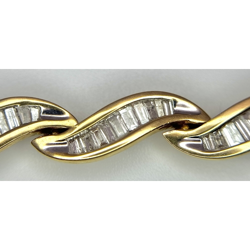 199 - A 14k Yellow Gold and Diamond Bracelet. Fifteen waves of tapered baguette cut diamonds - c.2.5ctw. 1... 