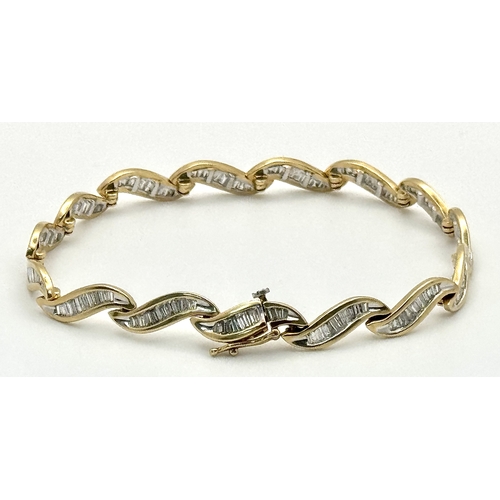 199 - A 14k Yellow Gold and Diamond Bracelet. Fifteen waves of tapered baguette cut diamonds - c.2.5ctw. 1... 