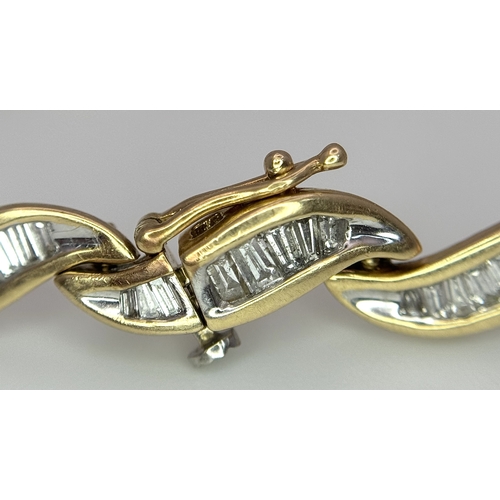 199 - A 14k Yellow Gold and Diamond Bracelet. Fifteen waves of tapered baguette cut diamonds - c.2.5ctw. 1... 