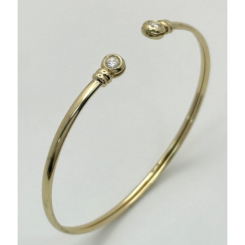 234 - A 9K Yellow Gold Cuff Bangle with White Stone Decoration. 3.1g total weight.
