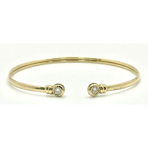 234 - A 9K Yellow Gold Cuff Bangle with White Stone Decoration. 3.1g total weight.
