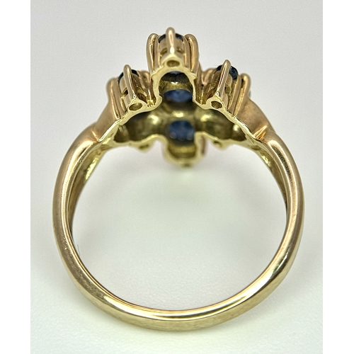 186 - A 9k Yellow Gold, Blue Sapphire Ring. Four 1.840ctw Oval cut Nigerian Sapphires with further accents... 