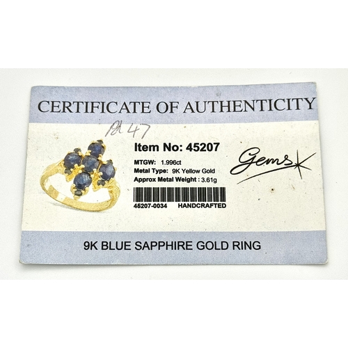 186 - A 9k Yellow Gold, Blue Sapphire Ring. Four 1.840ctw Oval cut Nigerian Sapphires with further accents... 