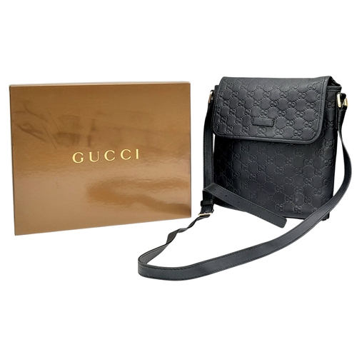 188 - A Gucci Black GG Messenger Guccissima Leather Crossbody Bag. Black Guccissima-embossed leather exter... 