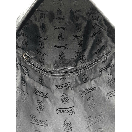 188 - A Gucci Black GG Messenger Guccissima Leather Crossbody Bag. Black Guccissima-embossed leather exter... 