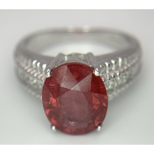 193 - An 18K White Gold, Royal Ruby and Diamond Ring. A 5.038 Madagascan oval cut Royal ruby with 0.084ctw... 