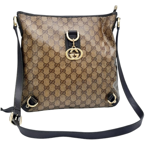 208 - A Gucci Brown GG Monogram Canvas Crossbody Bag. Brown GG monogram canvas exterior with gold-toned ha... 
