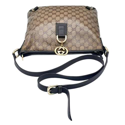 208 - A Gucci Brown GG Monogram Canvas Crossbody Bag. Brown GG monogram canvas exterior with gold-toned ha... 