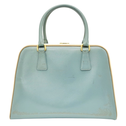 258 - A Prada Pale Green Saffiano Leather Frame Bag. Pale green saffiano leather exterior with gold-toned ... 