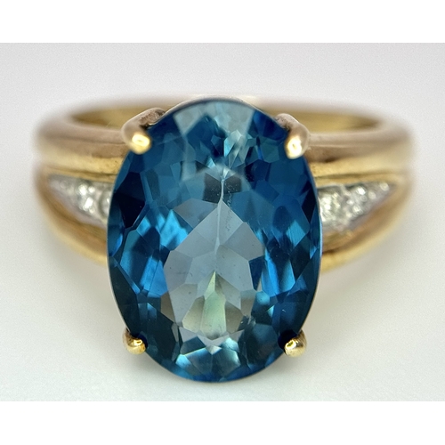 262 - A 9K Yellow Gold, London Blue Topaz and Diamond Ring. A 5.979ct, oval cut topaz with 0.056ct of Diam... 