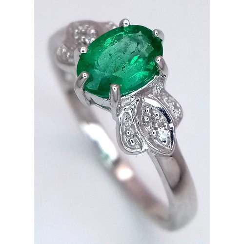 276 - A 9k White Gold, Emerald and Diamond Ring. An oval cut, 0.515ct Siberian emerald with 0.016ctw of di... 