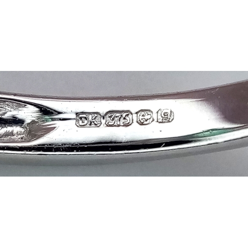 276 - A 9k White Gold, Emerald and Diamond Ring. An oval cut, 0.515ct Siberian emerald with 0.016ctw of di... 