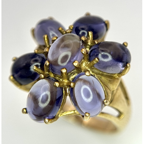 283 - A 9K Yellow Gold Iolite Gemstone Ring. Seven stones of 4.45ctw, oval cut Indian Iolites. Size N. 5.4... 