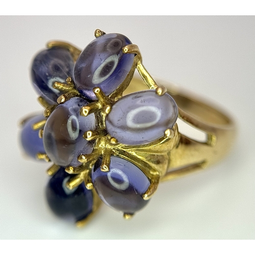 283 - A 9K Yellow Gold Iolite Gemstone Ring. Seven stones of 4.45ctw, oval cut Indian Iolites. Size N. 5.4... 