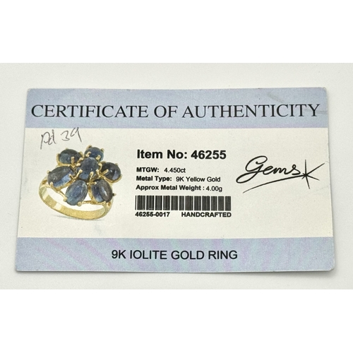 283 - A 9K Yellow Gold Iolite Gemstone Ring. Seven stones of 4.45ctw, oval cut Indian Iolites. Size N. 5.4... 