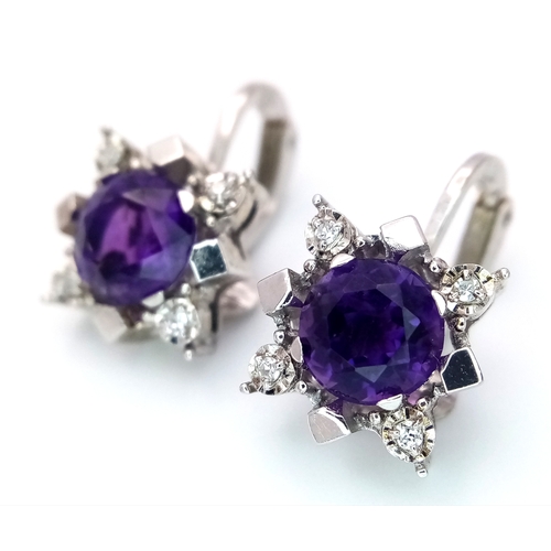 290 - A Pair of 14K Gold, Amethyst and Diamond Earrings. 2 x 1.5ct amethysts with 8, trillion cut diamonds... 